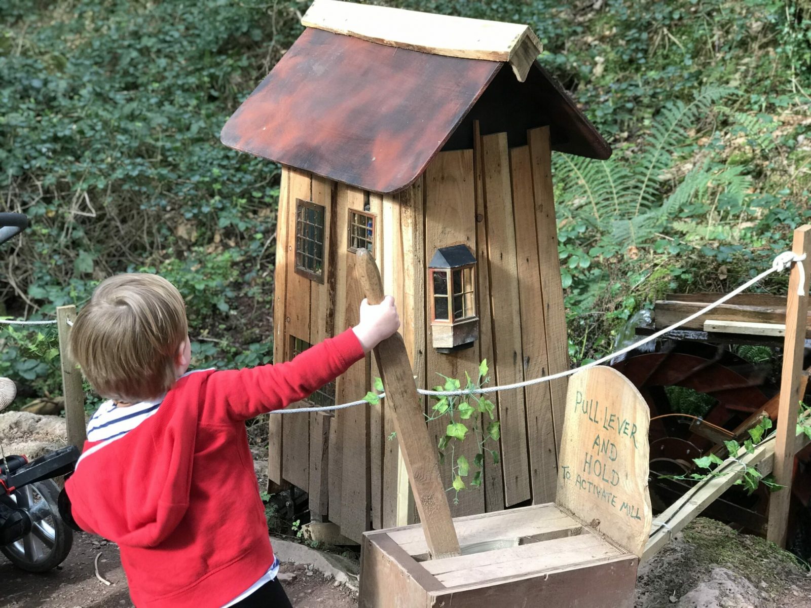 Dexter in bluestone's enchanted forest pulling a lever to make a waterwheel work