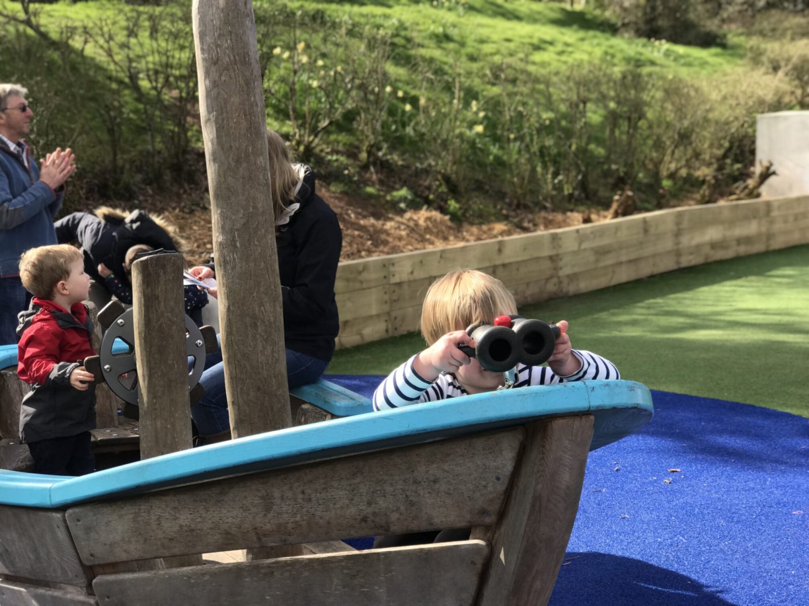dexter in a pirate ship using toy binoculars in bluestone's playground