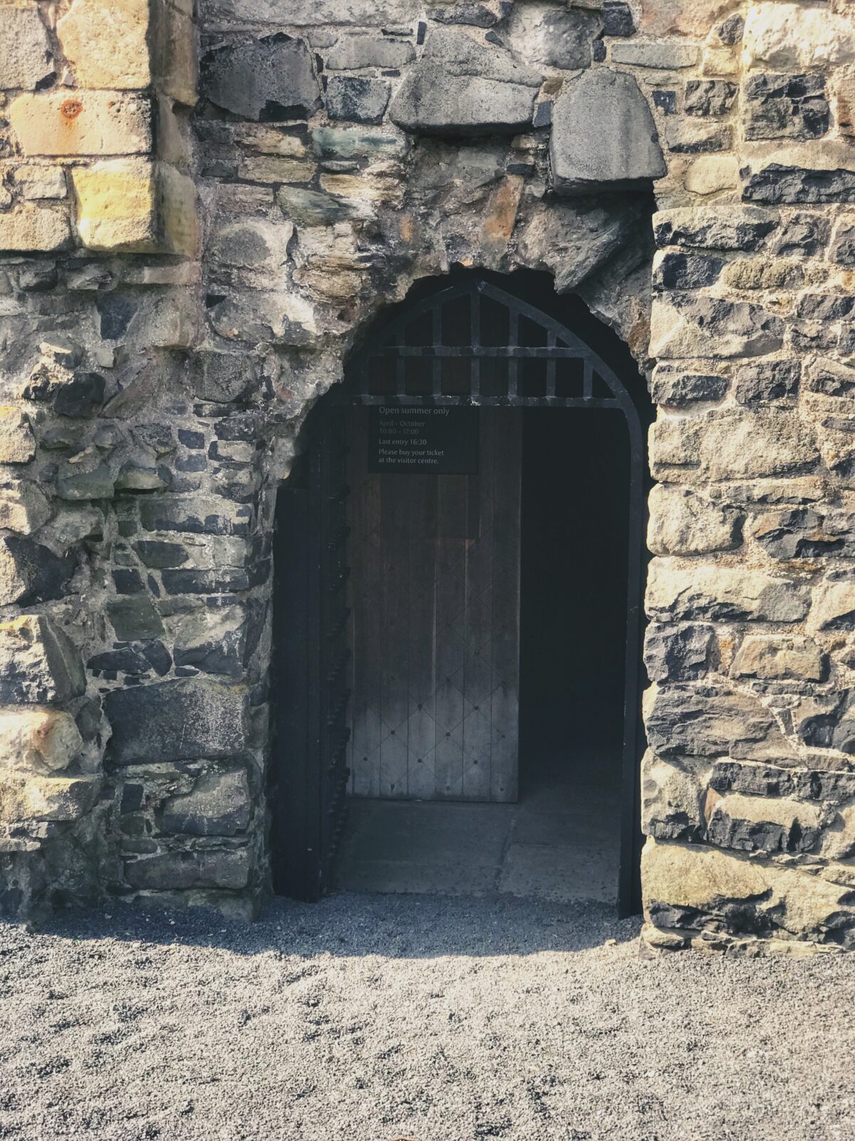 The doorway into Dundonald Castle with an iron arch and door