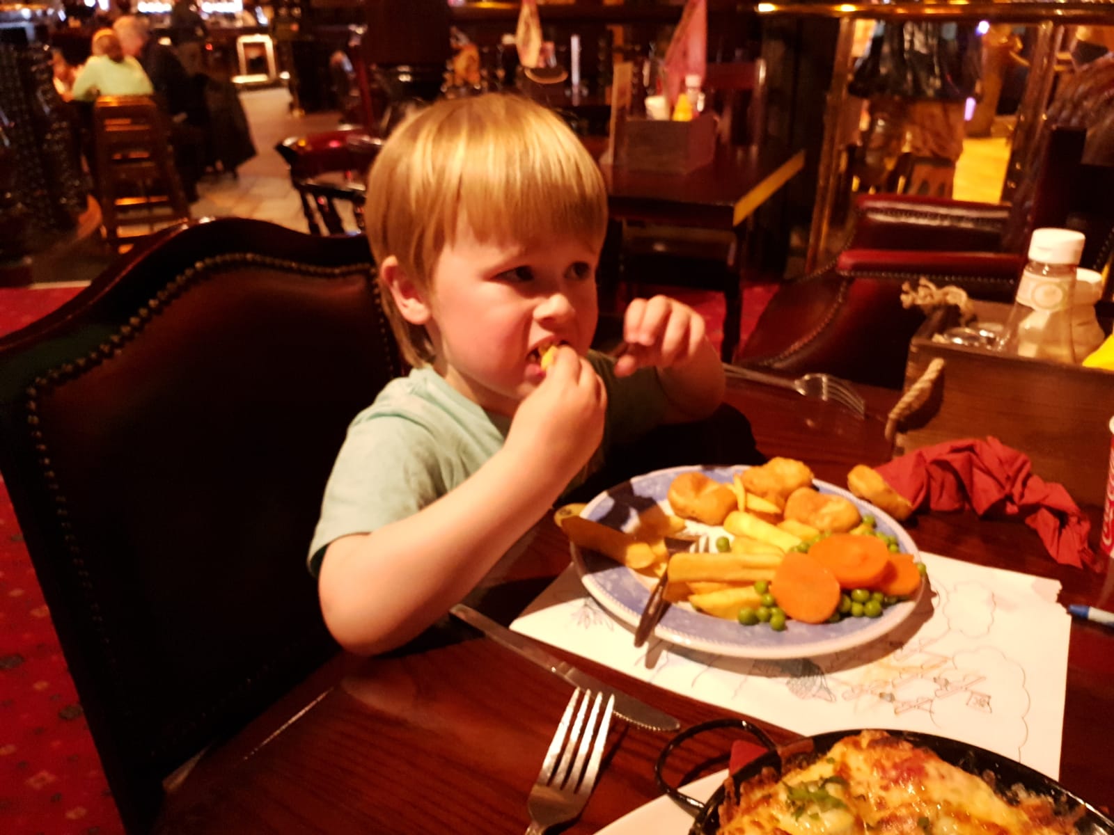 dexter eating his kids meal of chicken nuggets, chips and veg in the buccaneer, coral island, blackpool