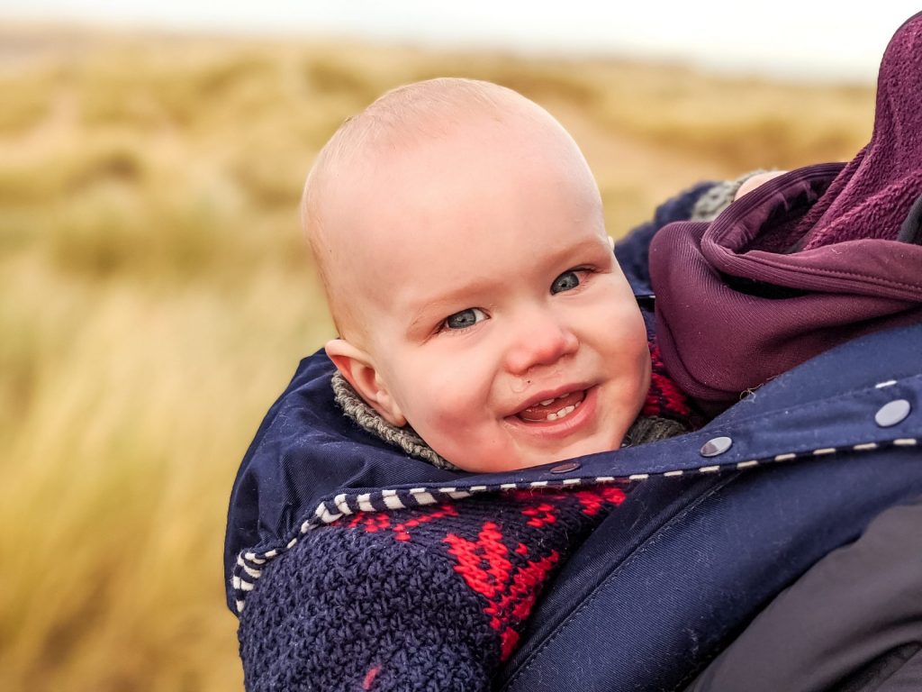 Felix on Ainsdale beach with the sand dunes in the background