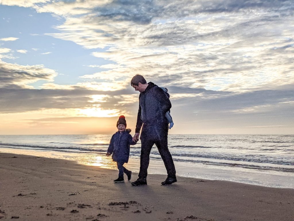 Neil and Dexter walking on Ainsdale beach