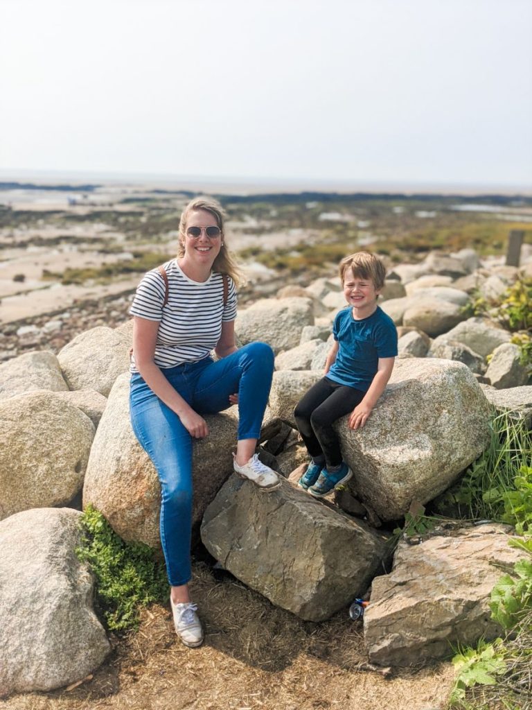 Nicola and Dexter posing on the rocks on Southerness beach