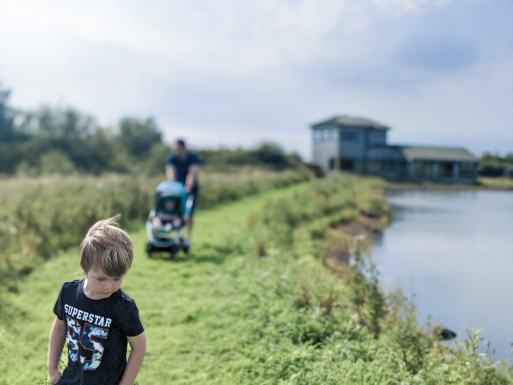 Dexter, neil and Felix on a trail at WWT Caerlaverock with the hide behind them